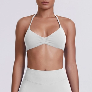 Close-up of white halter sports bra with gathered front and high-waisted yoga leggings set