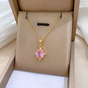 Close-up of pink oval gemstone necklace with white zircon accents in a luxury jewelry box