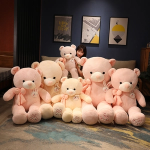 Pink and beige plush teddy bears with ribbon bows and rabbit embroidery in various sizes