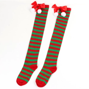 Detail of Christmas over-knee socks with red-green stripes, bows and white pom-poms
