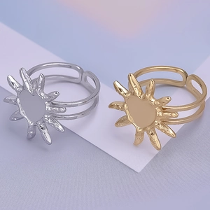 Detail of adjustable sunburst rings in gold and silver finish with heart center