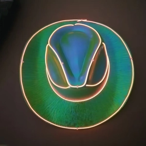 Close-up of LED neon light stitching on a holographic cowboy hat with orange fiber optics