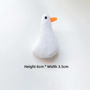 Detail view of mini plush white goose accessory with dimensions 6cm height and 3.5cm width