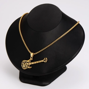 Retro rock guitar pendant necklace in gold finish with black details on a display bust