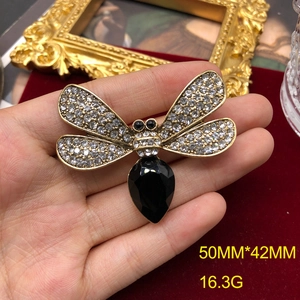 Vintage dragonfly brooch with rhinestones and black gemstone in gold finish
