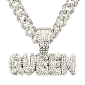 Macro shot of silver Cuban chain with diamond-encrusted QUEEN letter pendant