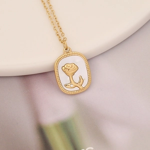 Gold oval pendant necklace with white shell inlay and rose relief with crystal accent