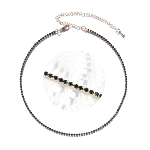 Close-up of gold chain necklace with dark green rhinestones and adjustable lobster clasp