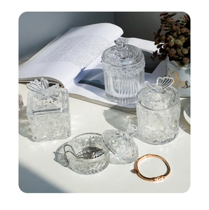 Detailed macro view of embossed glass jars with butterfly lids and jewelry storage