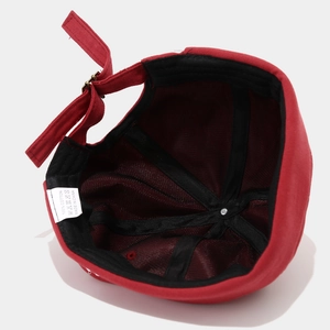 Internal structure of red cotton docker hat showing inner lining and metal buckle