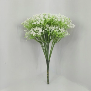 Macro shot of artificial gypsophila flowers with white petals and green stems for wedding decor