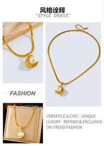 Detail of vintage gold plated moon crescent necklace with a large white pearl inlay