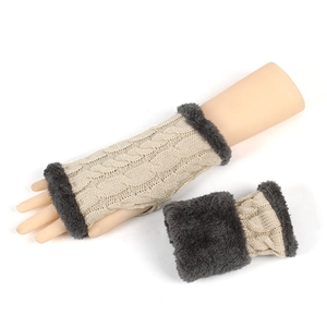 Detail of beige cable knit fingerless gloves with dark gray faux fur plush cuffs