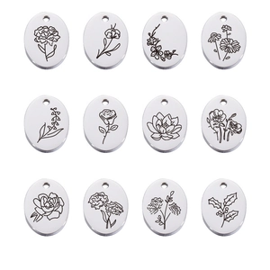 Detailed view of 12 oval stainless steel pendants with engraved monthly birthday flower designs
