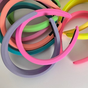 Padded sponge headbands in vibrant neon colors with handmade fabric texture labels