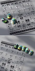 Detail of holographic butterfly and bow nail stickers with shimmering laser effect