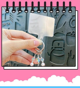 Close-up of crystal butterfly and pearl beaded phone charm with PVC patch