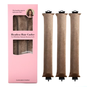 Three brown velvet heatless hair curlers next to pink box packaging on white background