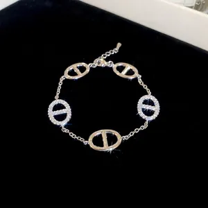 Elegant gold-plated oval link bracelet with zircon inlay on a black velvet background