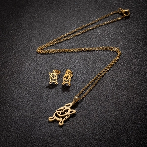 Golden French Bulldog jewelry set with necklace and stud earrings on black background