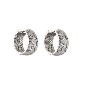 Detailed view of silver hoop earrings featuring micro-pave white and black cubic zirconia