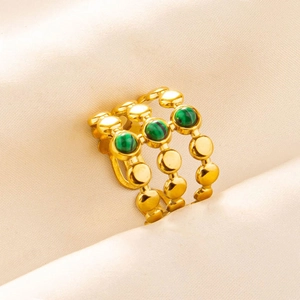 Macro detail of triple-band gold ring featuring three round green malachite stones