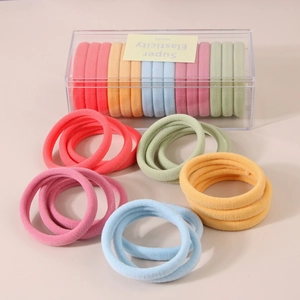 Macro detail of high elasticity colorful seamless hair ties set in a clear storage box