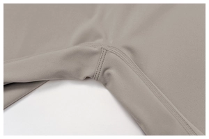 Macro view of high-density stitching and brushed matte grey fabric for yoga bodysuit