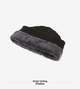 Detail of the thick dark grey fleece lining inside the black knitted beanie for winter