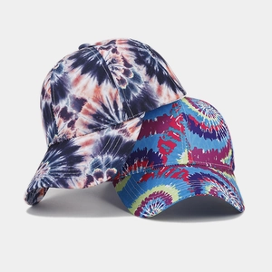 Close-up of vibrant tie-dye patterns and white stitching on cotton baseball caps