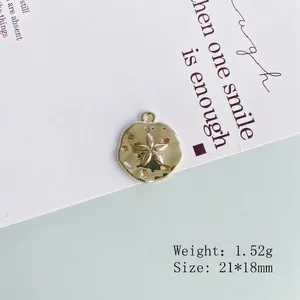 Detailed view of 21x18mm gold plated alloy pendant with fine hollow sand dollar design