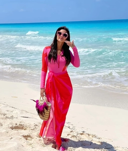 Pink and red zip-up long sleeve surf swimsuit with matching floral beach sarong wrap