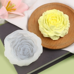 Detail of 3D peony flower silicone mold with finished candle on a decorative tray