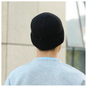 Detailed back view of a classic black ribbed knit beanie hat for winter warmth