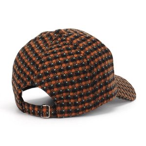 Detail of houndstooth baseball cap with adjustable metal buckle on back strap