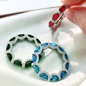 Detailed close-up of 925 silver rings with ruby and sapphire gemstones and micro diamonds