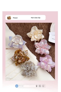 Detailed macro view of assorted colorful acetate rose flower hair claws on soft fabric