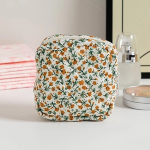 Quilted floral makeup bag for women with zip closure and elegant white floral pattern