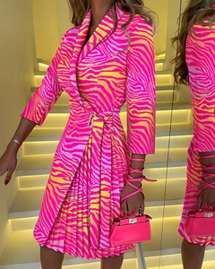 Detail of V-neck zebra print pleated dress with silver buckle belt and matching handbag