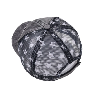 Close-up of vintage grey cotton baseball cap with black star mesh and distressed brim details