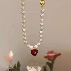 French style pearl necklace with a deep red magnetic heart pendant and gold clasp