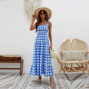 Detail of blue and white plaid maxi dress showing tiered skirt layers and elastic bodice