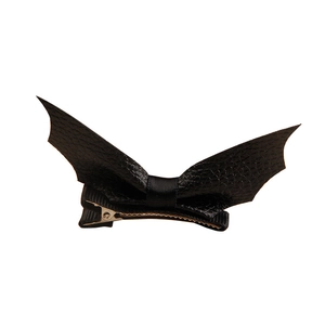 Halloween black bat wing hair clip with leather texture and ribbon bow on white background