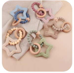 Detailed view of baby teething ring made of food-grade silicone stars and natural wood rings