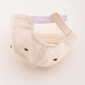 Beige kids baseball cap with adjustable velcro strap and embroidered eyelets rear view