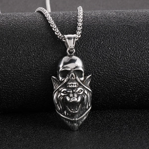 Close-up of gothic silver skull and lion head pendant on metallic bead chain