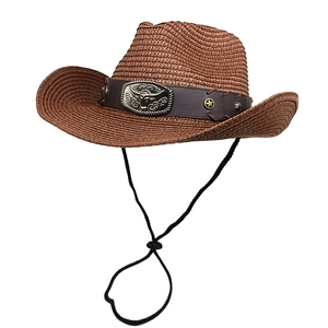Detail of western straw hat featuring silver bull head buckle and star stud headband
