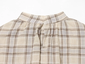 Close-up of the standing collar and back button closure on the plaid crop top