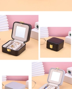 Detail of portable square jewelry box with velvet lining, mirror, and ring storage slots
