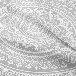 Close-up of bohemian mandala pattern on soft white fabric with grey floral print detail